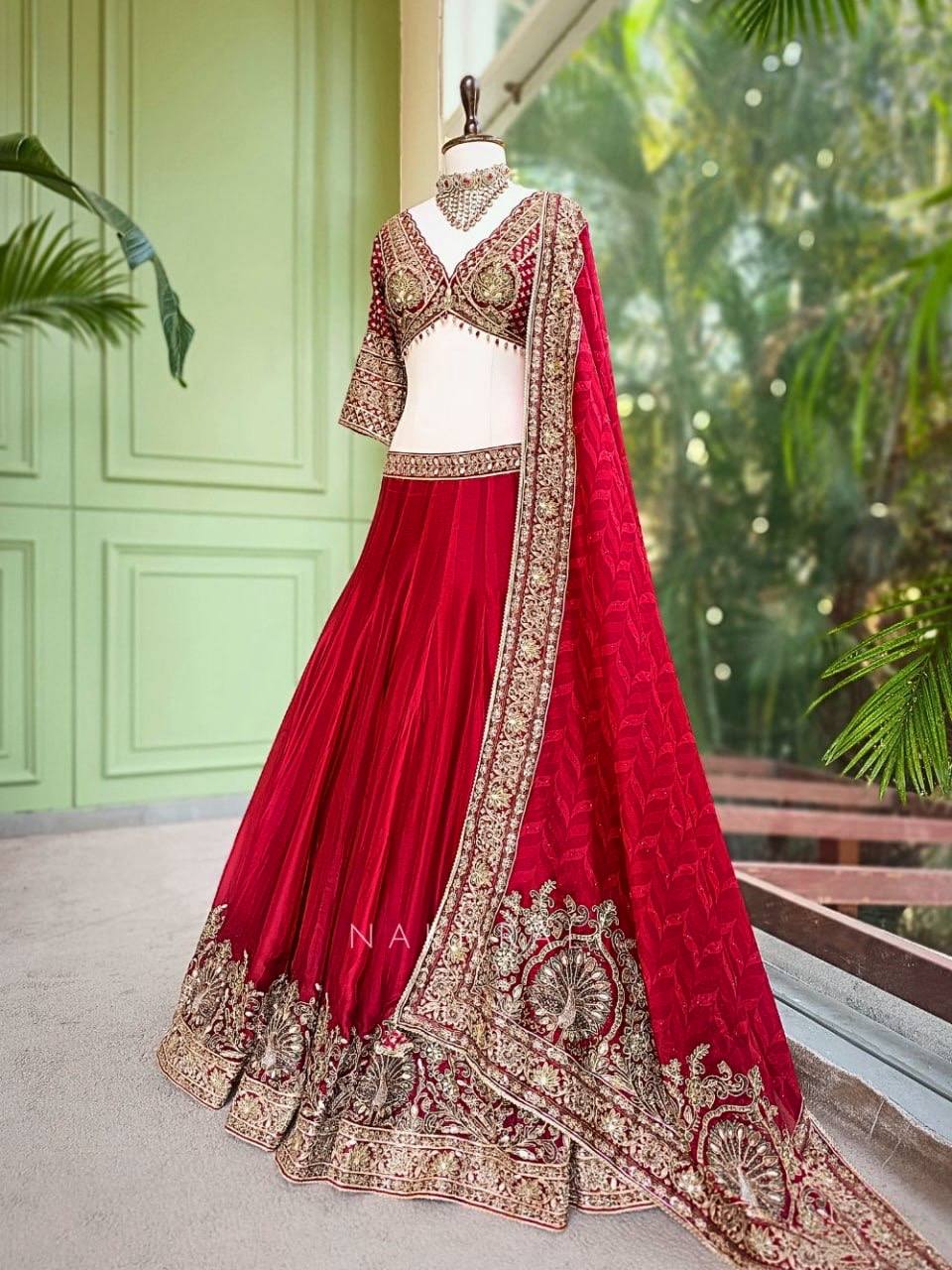 Regal Crimson Red Bridal Lehenga Choli Ensemble Featuring Intricate Gold Zari Embroidery, Heritage Motifs, and Embellished Tassels